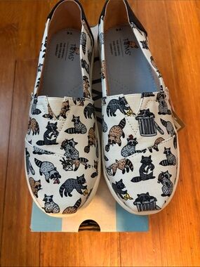 Toms Kids White Canvas Slip-On Shoes with Black and Brown Raccoon Print